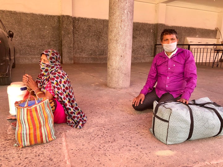 Bal Mukund and his wife Manju, migrant workers from Bihar, in a medical screening queue in Chhatarpur, New Delhi, on 18 May. 