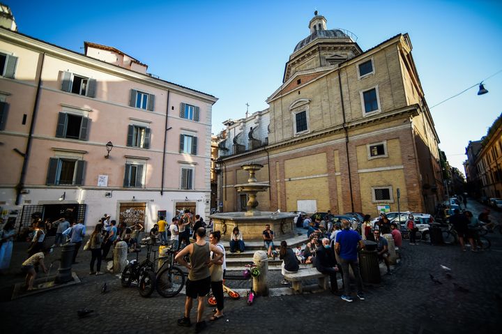 People drink in a square in Rome on May 21, 2020, despite government warnings that people should continue to respect social distancing rules.