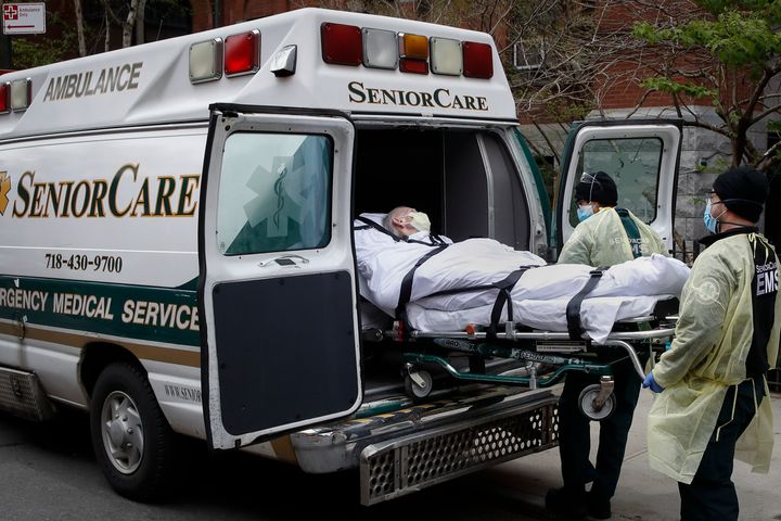 FILE - In this April 17, 2020, file photo, a patient is loaded into an ambulance by emergency medical workers outside Cobble Hill Health Center during the coronavirus in the Brooklyn borough of New York. (AP Photo/John Minchillo, File)