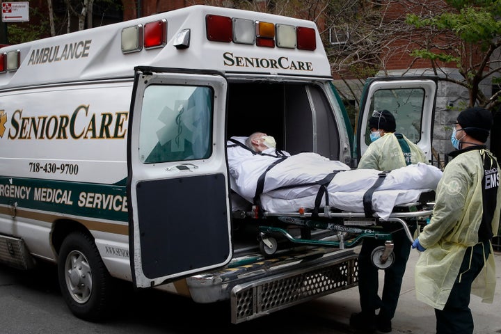 FILE - In this April 17, 2020, file photo, a patient is loaded into an ambulance by emergency medical workers outside Cobble