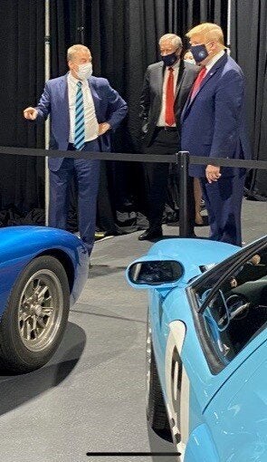 Bill Ford Jr., executive chairman of Ford Motor Co., points to a collection of Ford GT vehicles while talking with President Donald Trump in a mask during his visit to the Rawsonville plant in Ypsilanti on May 21. Mark Meadows, White House chief of staff, is standing in the middle.