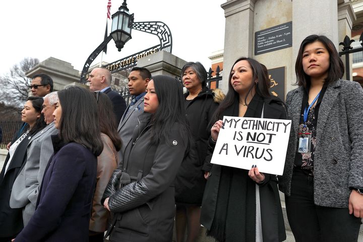 Members of the Asian American Commission, on the steps of the Massachusetts State House in Boston, condemn racism towards their community on March 12, 2020. 