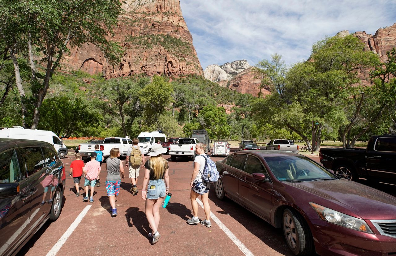 Visitors leave the Zion Lodge parking lot to go on hike in Zion National Park on May 15 in Springdale, Utah. Zion National Park had a limited reopening Wednesday as part of its reopening plan after it was closed due to the COVID-19 pandemic.