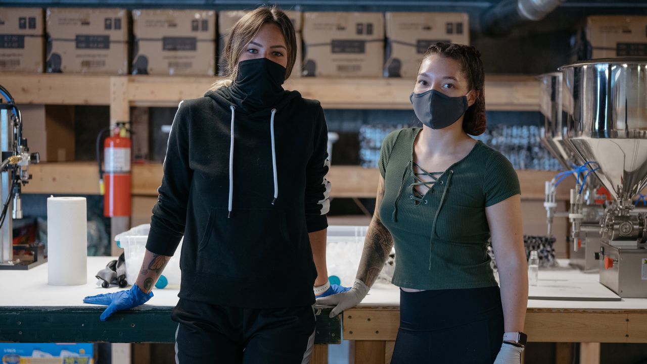 Makayla Deppa and Amanda Halverson were strippers before the coronavirus shut down their workplaces. They now work at the Hygiene Hustle hand sanitizer facility in north Seattle. The factory produces 2,000 bottles of hand sanitizer a day, most of which are given away to street-based sex workers.