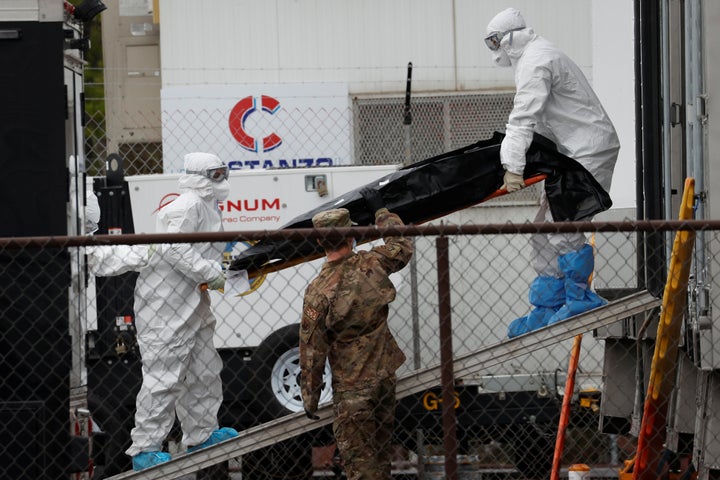 Workers move a deceased coronavirus patient in New Jersey.&nbsp;