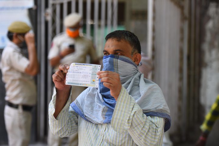 A man holds a railway ticket outside the reservation counter that was reopened following the ease in lockdown restrictions, in New Delhi Railway Station, on May 22, 2020 in New Delhi.