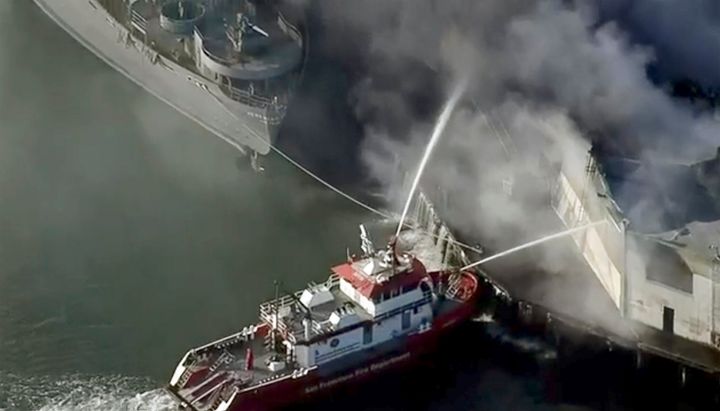First responders battle a massive fire that erupted at a warehouse early Saturday, May 23, 2020 in San Francisco.