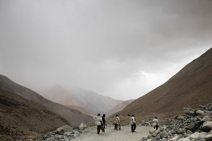 In this picture taken on May 18, 2019, road maintenance workers seen near Pangong Lake road near the Chang La pass in Ladakh region.