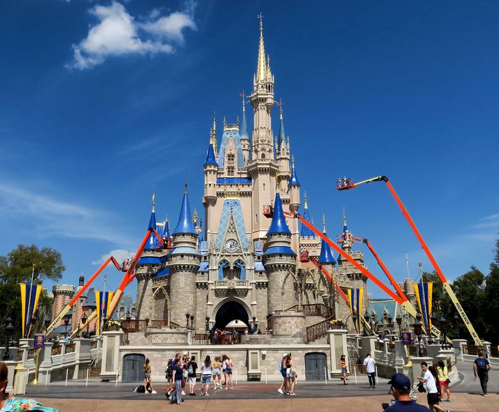 Workers at Walt Disney World paint Cinderella Castle in the Magic Kingdom, in Lake Buena Vista, Fla., on March 12, 2020. (Joe Burbank/Orlando Sentinel/Tribune News Service via Getty Images)