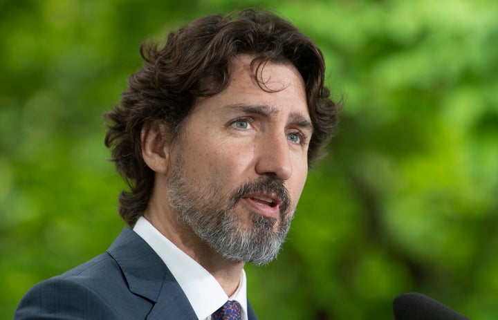 Prime Minister Justin Trudeau responds to a question from a member of the media on site during a daily news conference outside Rideau Cottage in Ottawa on May 25, 2020.