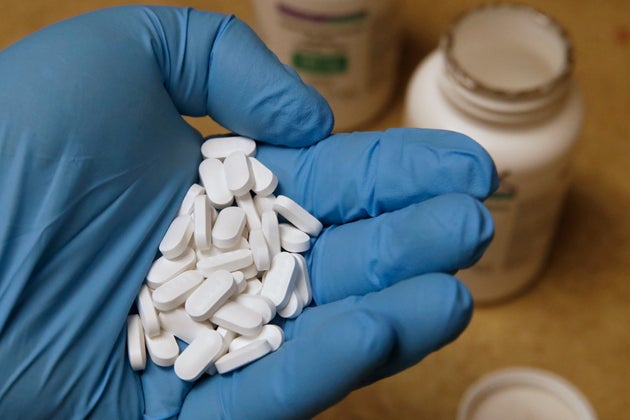 A pharmacy tech holds pills of Hydroxychloroquine on May 20,