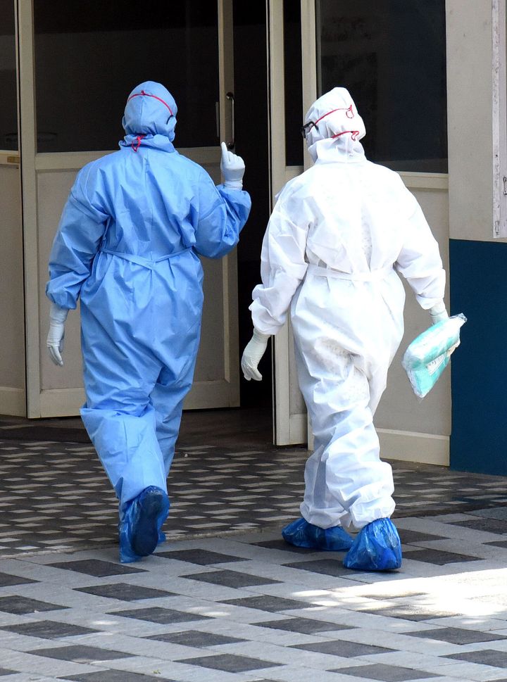  Medical workers wearing protective suits seen outside a special isolation ward of a Hospital in Kochi, Kerala, March 19, 2020.