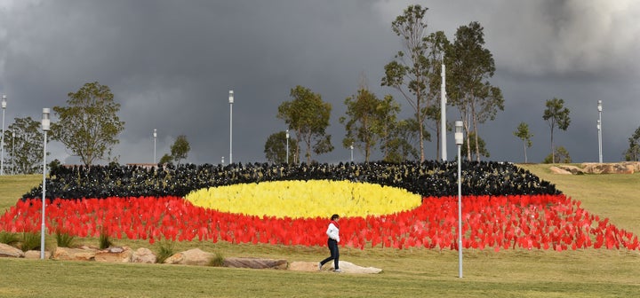 TOPSHOT - A woman passes a huge art installation called 'Sea of Hands' which consists of thousands of hands in the colours of the Aboriginal flag red, yellow, black.
Part of National Reconciliation Week 2016, the installation is for Australians to reflect on Australias national identity and the place of Aboriginal and Torres Strait Islander histories and cultures in the nations story.
/ AFP / William WEST (Photo credit should read WILLIAM WEST/AFP via Getty Images)