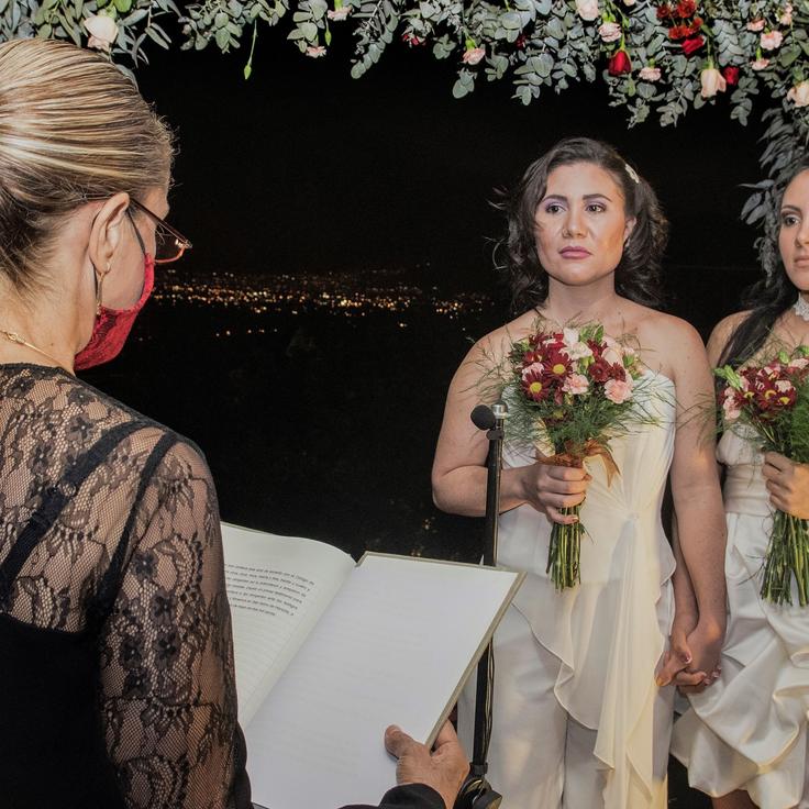 Alexandra Quiros (C) and Dunia Araya (R) stand before a lawyer during their wedding in Heredia, Costa Rica, Tuesday. 