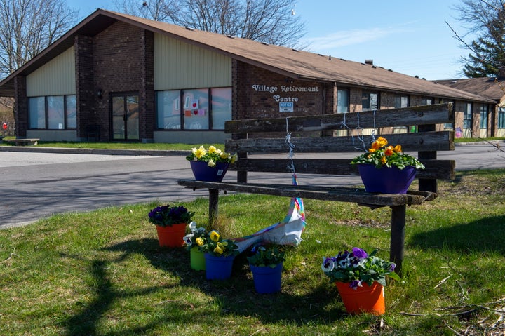 Flowers sit on a bench in front of Orchard Villa care home in Pickering, Ont., on April 27, 2020. This facility is one of five mentioned in a new report on long-term care homes in Ontario.