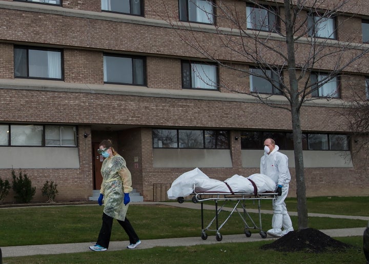 A body is wheeled from the Eatonville Care Centre in Etobicoke, Ont. during the COVID-19 pandemic on April 14, 2020. 