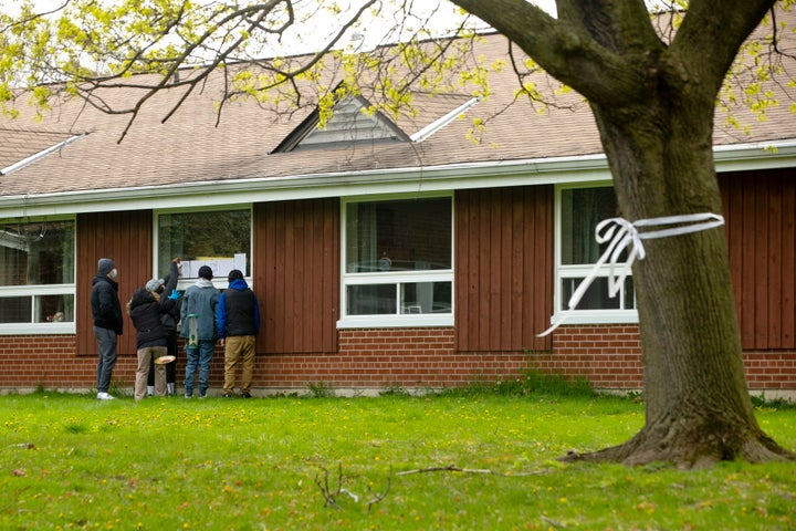 A resident at Altamont Care Community in Scarborough, Ont. receives a Mother's Day visit from her family on May 10, 2020. 