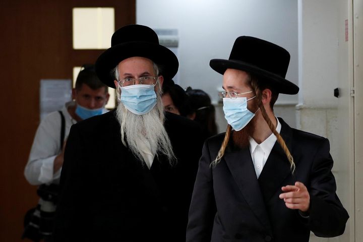Ultra-Orthodox Jewish men, family members of Malka Leifer, a former Australian school principal accused of sexually assaulting students, walk outside the courtroom as a ruling is underway in Leifer's case, at Jerusalem District Court May 26, 2020. REUTERS/Ronen Zvulun