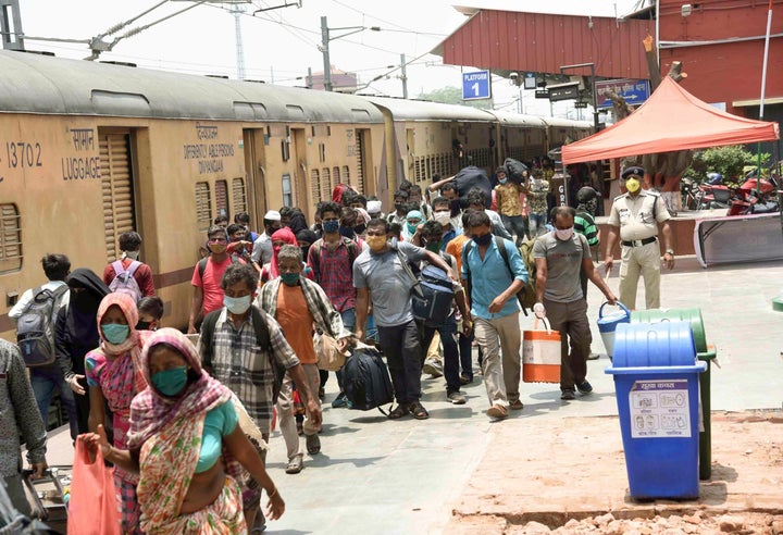 Migrants leave after arriving by a Shramik special train at Danapur station, on May 25, 2020 in Patna, India. 