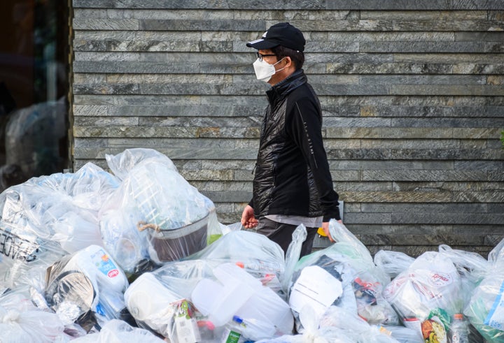 A person wears a protective face mask in New York during the coronavirus pandemic on May 21. The pandemic has allowed plastic bags and other items to make a comeback around the world.