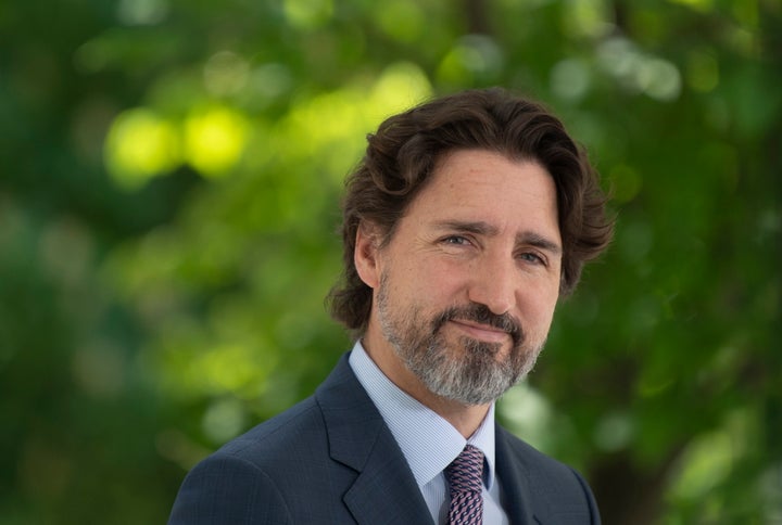 Prime Minister Justin Trudeau listens to a question from a reporter during a news conference outside Rideau Cottage in Ottawa on May 27, 2020.