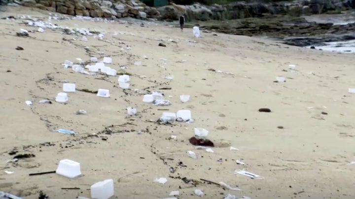 Masks and other plastic materials, are seen, after they were washed up because of damaged shipping containers on the Malabar beach, Sydney, Australia, May 27, 2020.