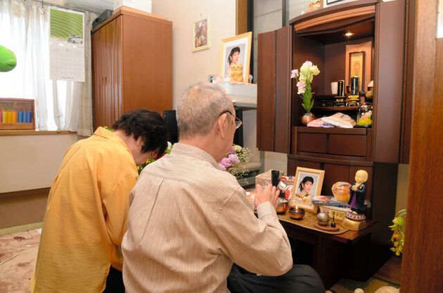 仏壇に手を合わせる石田奈央美さんの両親=2020年5月27日午前、京都市伏見区、代表撮影