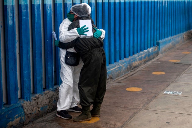 A woman mourns the dead of her husband victim of the new coronavirus, COVID-19, outside the emergency area at Alberto Sabogal Hospital in Lima, on May 27, 2020. - Peruvian Health Minister insisted on Wednesday, that Peru has entered a plateau in the curve that registers the expansion of new coronavirus infections, a day after the Pan American Health Organisation (PAHO) warned that COVID-19 transmission is accelerating in this country as in Brazil and Chile. (Photo by ERNESTO BENAVIDES / AFP) (Photo by ERNESTO BENAVIDES/AFP via Getty Images)