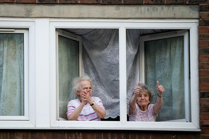Residents in nearby houses outside the Whittington Hospital in London join in the weekly "Clap for our Carers"
