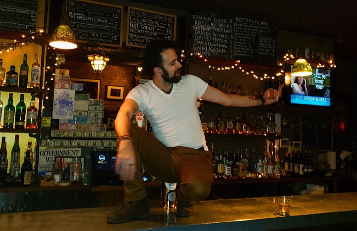 Kenneth John Jimenez, 36, working at a bar in Brooklyn, New York, where he made $9 an hour plus tips. Now he's getting $600 a