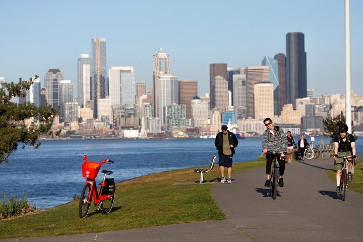 Cyclists at Seattle's Alki Beach Park on March 20. The city is creating new bike lanes and expanding sidewalks.