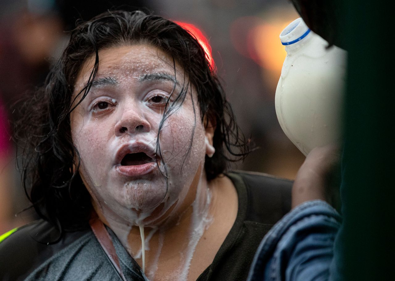 Milk drains from the face of a protester who had been exposed to percussion grenades and tear gas outside the Minneapolis Police 3rd Precinct on Tuesday, May 26.