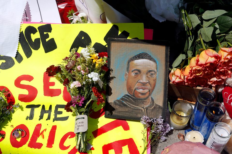 A chain portrait of George Floyd is part of the memorial for him near the site of the arrest.