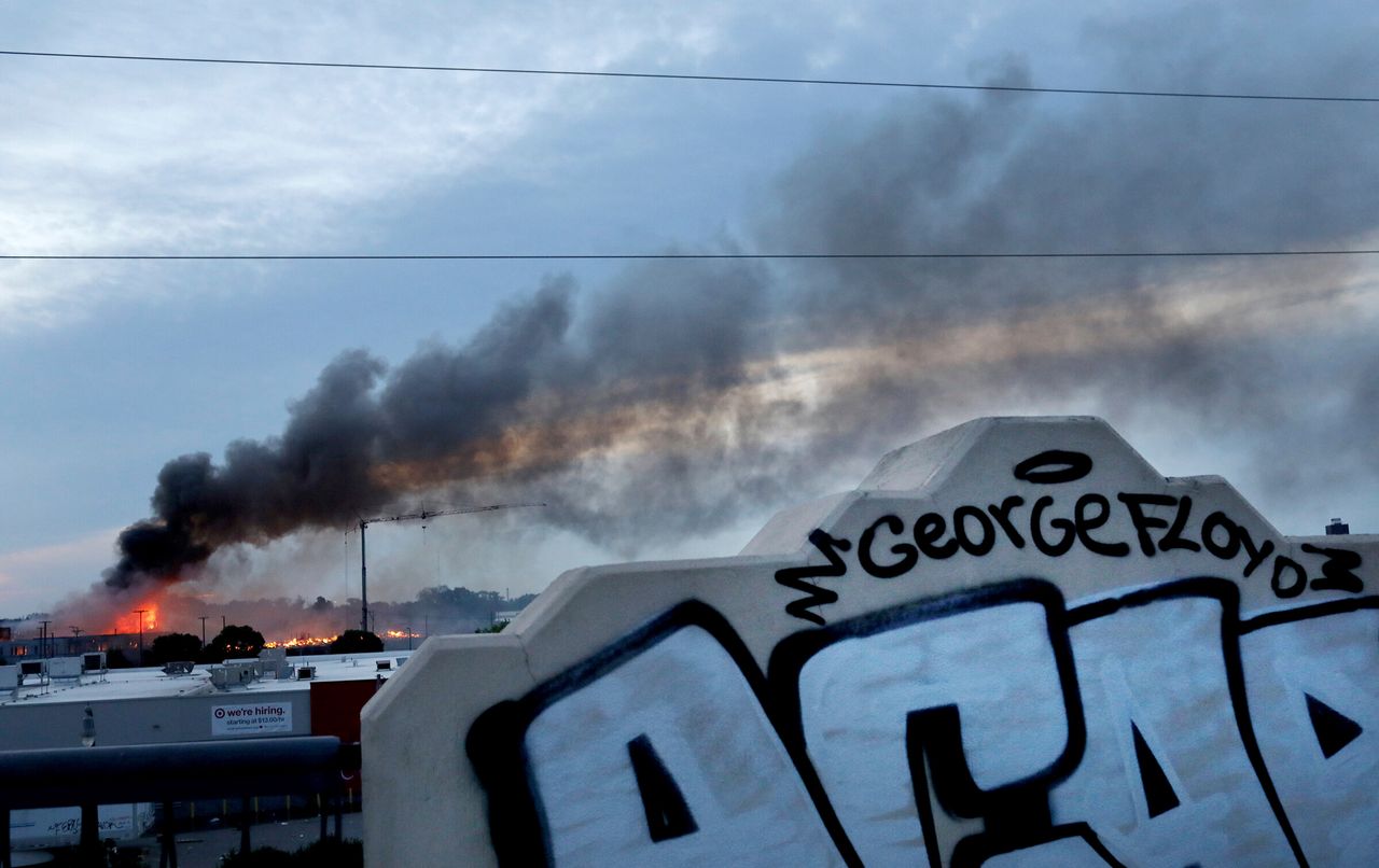 Smoke fills the sky after a night of unrest and protests in the death of George Floyd early Thursday.