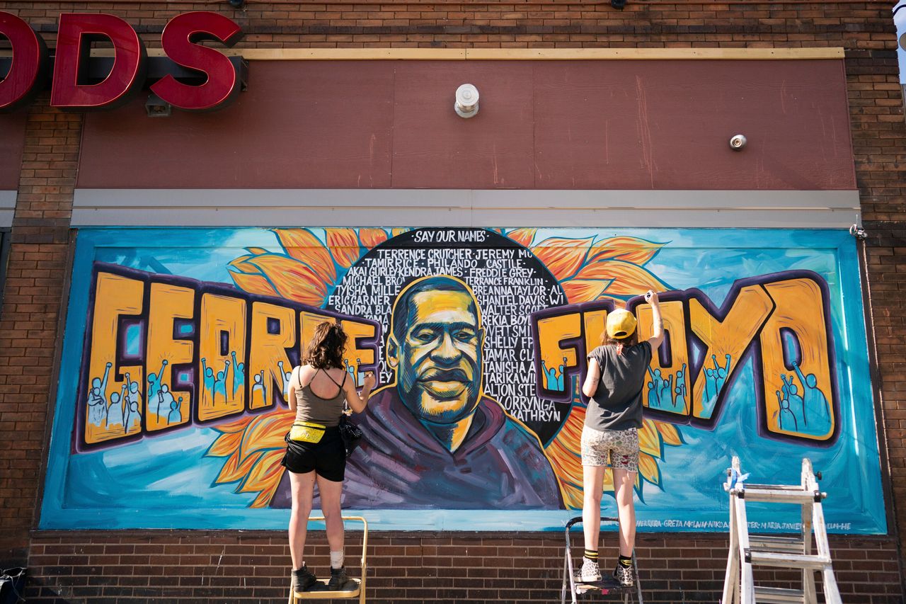 Artists complete a mural of George Floyd outside of Cup Foods in Minneapolis. 
