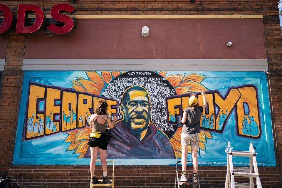 Artists complete a mural of George Floyd outside of Cup Foods in Minneapolis. 