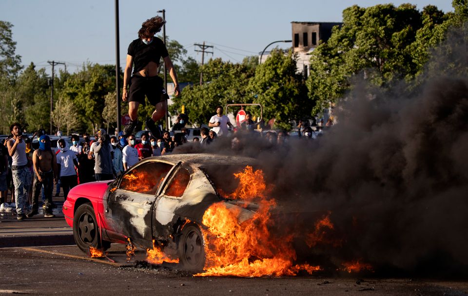 A car burns in a Target parking lot on Thursday.