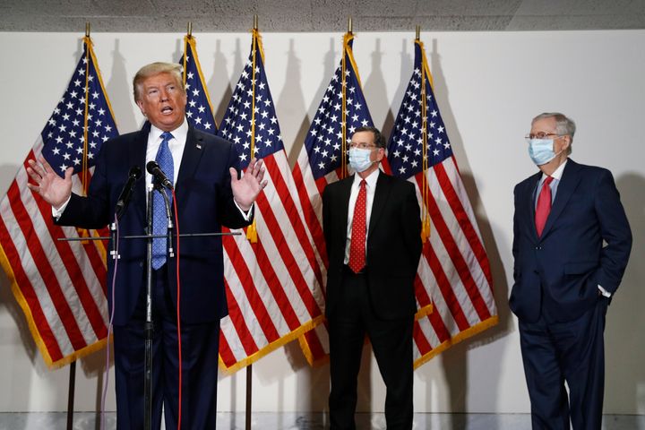 President Donald Trump at the Capitol earlier this month, speaking to reporters. Behind him are (center) Sen. John Barrasso (R-Wyo.) and Senate Majority Leader Mitch McConnell (R-Ky.).