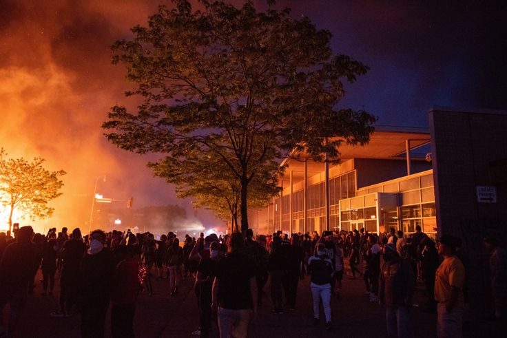 A crowd watches a pawnshop burn to the ground on Thursday night. It was the third day of protests over the death of George Floyd in Minneapolis.