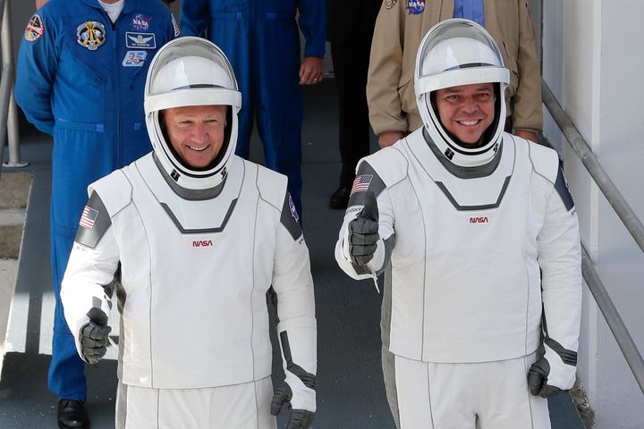 NASA astronauts Douglas Hurley, left, and Robert Behnken make their way to Pad 39-A, at the Kennedy Space Center in Cape Canaveral, Fla., on Saturday.