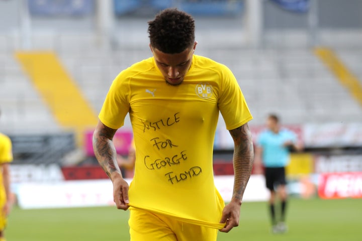 Dortmund's English midfielder Jadon Sancho shows a "Justice for George Floyd" shirt after scoring his team's second goal during a Bundesliga match on Sunday.