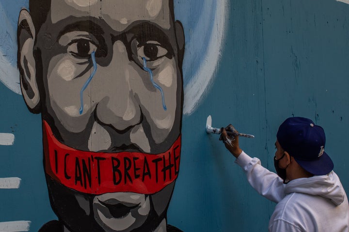 The artist Celos paints a mural in Downtown Los Angeles on May 30, 2020 in protest against the death of George Floyd.