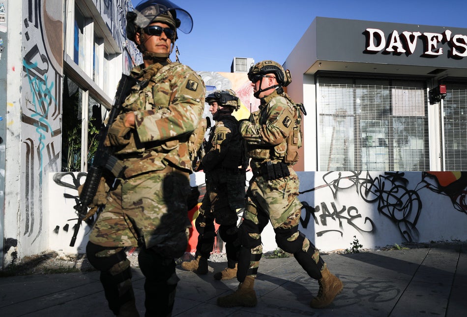 On May 31, 2020, U.S. National Guard troops patrol in L.A.'s Fairfax District, which was damaged during unrest the day before. The troops were called in by California Gov. Gavin Newsom following violent demonstrations in response to George Floyd’s death.