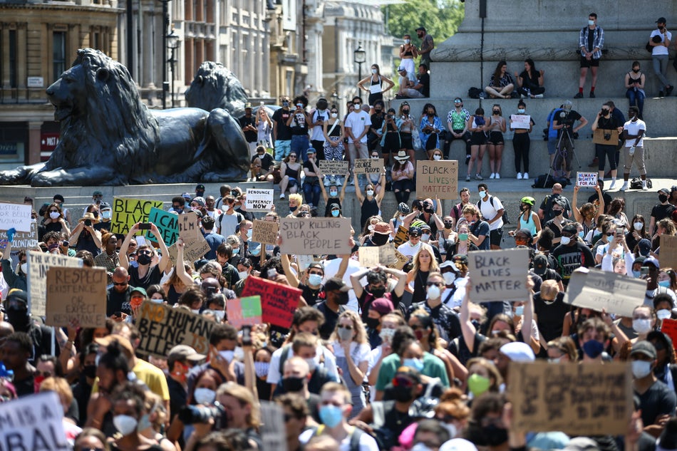People in London hold placards as they join a spontaneous Black Lives Matter march at Trafalgar Square on May 31, 2020.