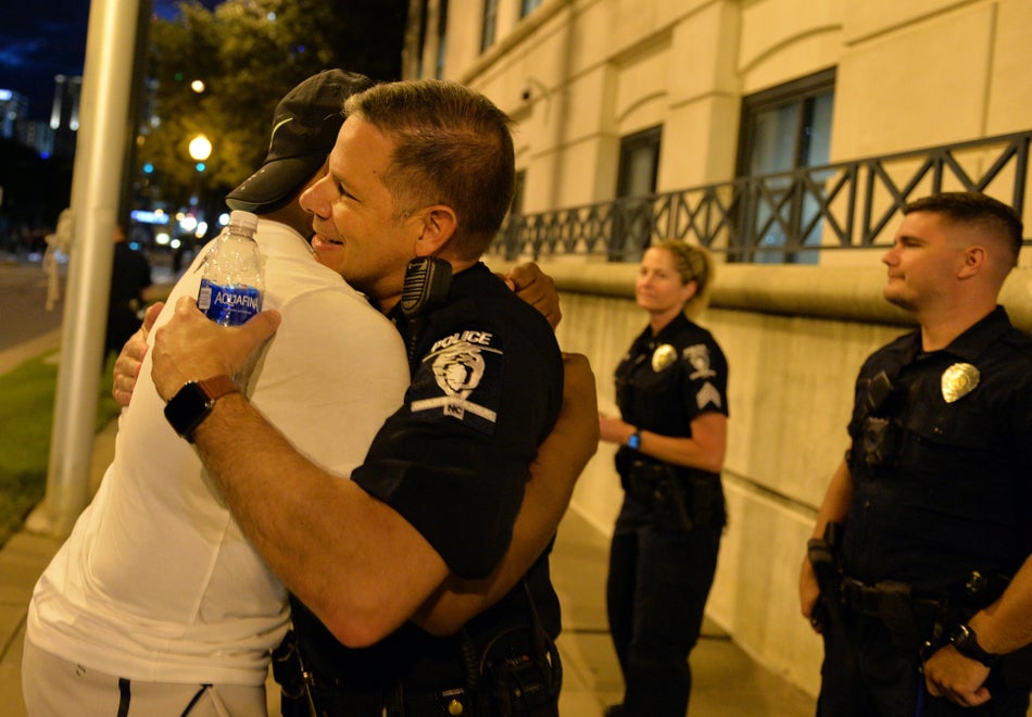 A demonstrator and a police officer hug in Charlotte, N.C. on May 30, 2020.
