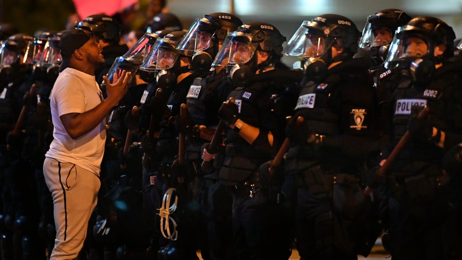 A demonstrator in Charlotte, N.C. speaks to police on May 30, 2020.