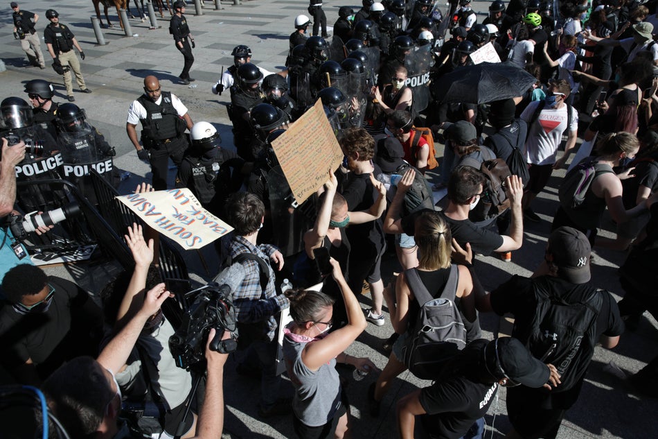 Demonstrators, gathered at Lafayette Park across from the White House on May 30, 2020, attempt to breach a police barricade during a protest.