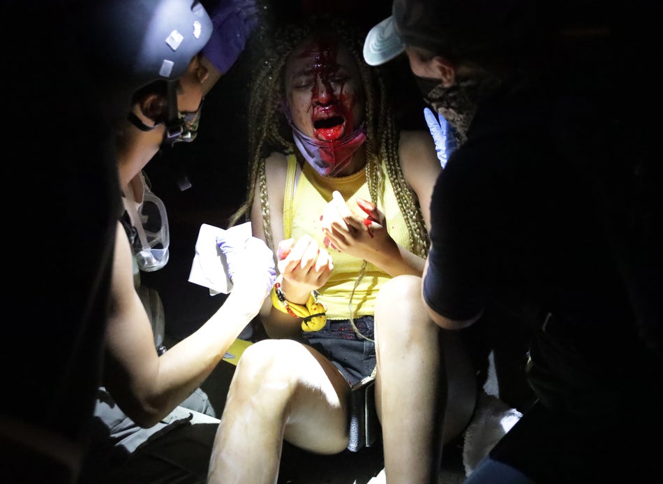 An injured women is tended to near the White House on May 30, 2020 during a protest of the killing of George Floyd.
