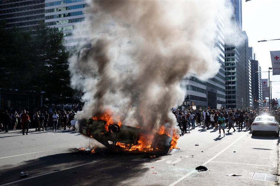 Smoke rises from a fire on a police cruiser in Center City during the Justice for George Floyd Philadelphia Protest on May 30, 2020.
