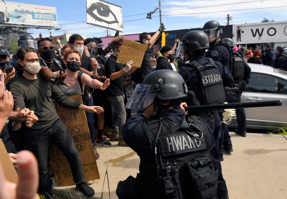 A Los Angeles police officer threatens demonstrators during a protest over the death of George Floyd on May 30, 2020.